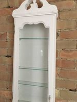 Front and side views of the white repainted wall cabinet showing glass door and glass shelves inside.