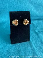Front view of earrings on display stand