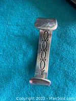 Front view of cuff showing stamped silver overlay design