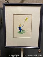 Full view of framed watercolor painting showing child with kite against white background.