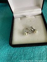 Photo of pair of vintage white gold screw-on pearl earrings in box