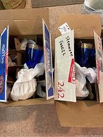 Two blue chalices with gold rims packed in original boxes with packing paper.