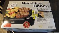 Photo of Hamilton Beach HealthSmart grill in original box with product image and specifications visible.