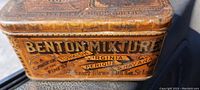 Close-up of Benton Mixture branding side of the antique tobacco tin showing litho graphics and text.