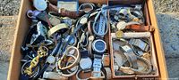 Box flat full of many wrist watches assorted styles and brands including analog and digital faces, metal and leather straps.