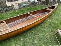 Interior view showing cedar strip hull construction, wooden ribs, canoe depth and length