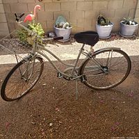 Side view of vintage Ross women's bicycle showing compact tempered steel frame, front basket, saddle, rear rack, and tires.