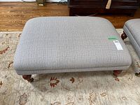 Top view showing light gray textured fabric upholstery and rectangular shape, with a sticker labeled 225.