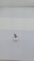 Front view of brand new AAA red garnet silver ring on white background.