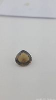 Pear teardrop cut loose champagne citrine gemstone, showing overall shape and color on white background