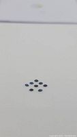 Eight marquis cut blue sapphire stones arranged on a plain white background.