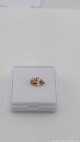 Top-down view of pear-shaped gemstone in display box