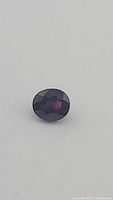 Top-down view of oval sapphire on white background