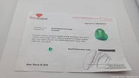 Certificate of appraisal from Gem Analysis dated March 10, 2018 showing heart cut emerald and appraisal details.