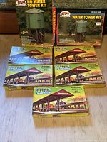 Two water tower kits and four station platform kits arranged on the floor.