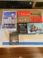 Five items shown together including kits and game boxes on wooden counter