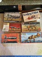 Top-down photo showing all six airplane model kits boxes arranged on a table, box art visible for each model.