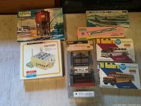 Full spread of all boxed model train kits and accessories on display showing branding and different items included in the lot.