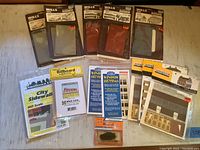 Collection of new OO scale scenery kits and accessories by Wills and Miniature Scenery on a table surface.
