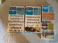 Four original boxes of Preiser miniature figures including railway personnel, seated persons, and military figures.