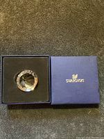 Swarovski crystal paperweight in original blue box with black interior.