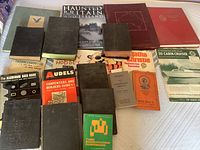 Wide shot showing the full assortment of vintage books spread on a flat surface, highlighting variety and condition.