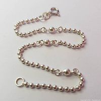 Full view of the silver bead chain bracelet showing its entire length and design.