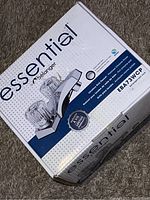 Photo of Belanger Essential water faucet box showing product image and branding, highlighting chrome finish and clear knob handles.