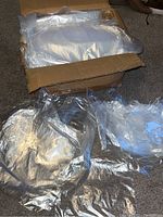 Photo showing a box filled with a bundle of clear plastic bags, partially opened to reveal the contents inside.