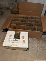 Box containing 20 canning jars separated by cardboard dividers.