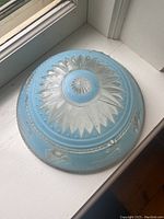 Top view of the vintage blue glass lampshade showing geometric starburst patterns and textured finish.