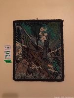Front view of the rectangular handmade hooked rug with dark border showing detailed hooked wool fabric in green, brown, white, and gray colors forming a natural woodland design.