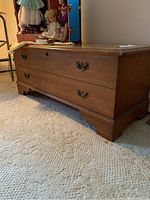 Front and side view of wooden Lane cedar chest showing drawers and metal handles