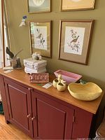 Wide shot showing all items on a wooden sideboard including 4 ceramic planters, white cookie jar, and bird figurine on wooden base