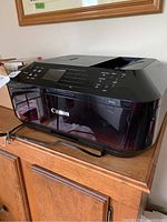 Side view of Canon MX922 printer showing control panel and paper feeder