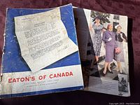Cover of 1952-1953 Eaton's of Canada catalog showing title and a letter on worn blue background