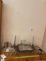 Front view of silver, crystal, and glass items arranged on wood surface