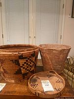 Three baskets side by side on table, front view