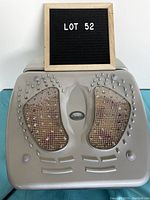 Front view of the beige iComfort infrared circulation massager showing mesh footrests and round massage nodes.