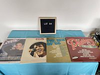 Four vinyl albums laid out flat: Connie Francis, Elvis Presley, The Best of '66, The Platters Greatest Hits