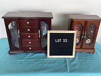 Full front view of both jewelry boxes side by side with lot number sign in between.