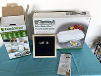 Kenmore Select Seal-n-Save Vacuum Sealer System original box, FoodSaver accessory box, instruction manual, and small letter board showing Lot 18