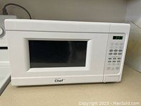 Front view of white Master Chef microwave oven with control panel and digital display.