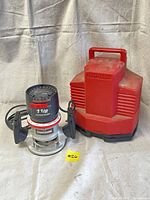 Craftsman 1 1/2 HP Router with Red Carrying Case shown together on a cloth background.
