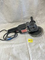 Full view of the black Craftsman sander polisher with attached power cord and side handle, showing the tool's overall condition and sanding pad size.