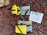 Top view of LOGAN F300-2 Pro Joiner, block plane, instruction sheet and F200 Sander on patterned carpet.