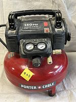 Front view of Porter Cable 6 gallon pancake compressor showing tank, gauges, and power switch.