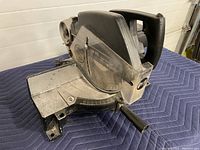 Side view of Black & Decker miter saw showing metal base and handle