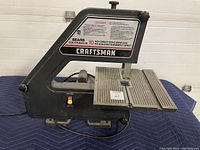 Left side view showing Craftsman branding, working table surface, power switch, and warning label.
