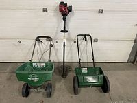 Front view of the trimmer with two spreaders positioned against a white wall showing details and scale.